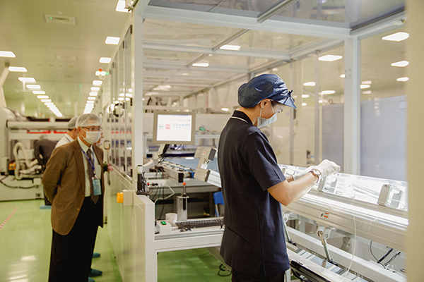 Employees in a manufactruing plan evaluating their work.